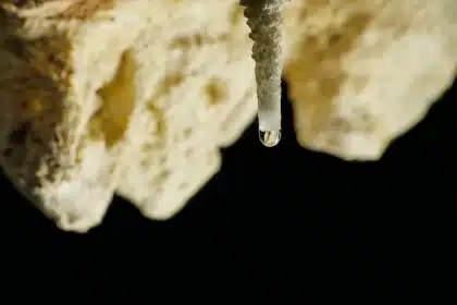 Peaceful spa treatment in an underground limestone cave with stalactites and clear water below
