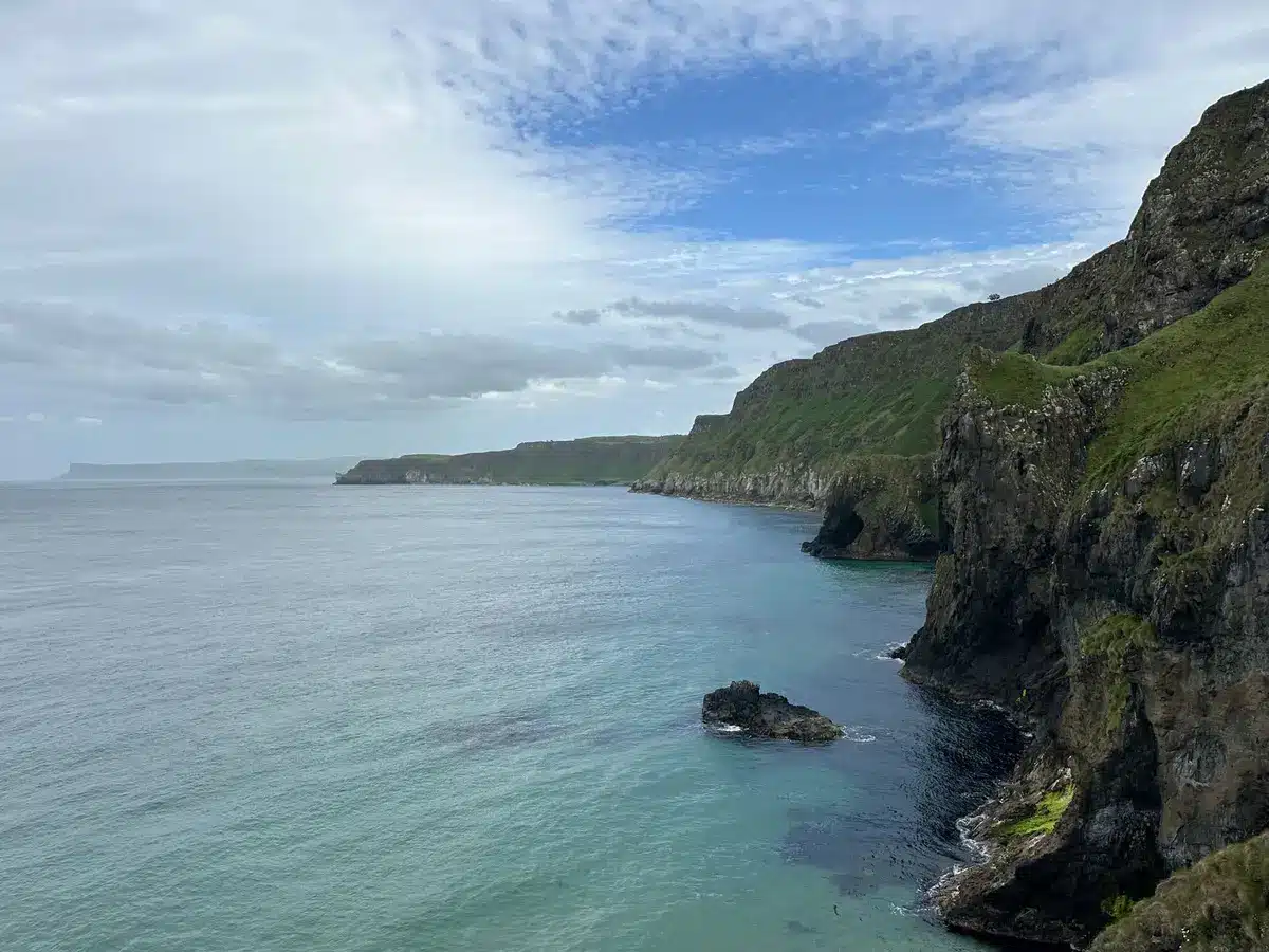 Coastal beach with dramatic layered cliffs and sea caves, typical of Waterford's underrated shorelines