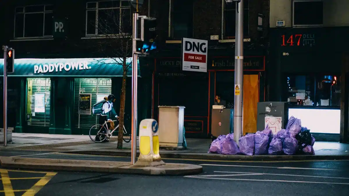Neon-lit Dublin city street at night with emergency services presence