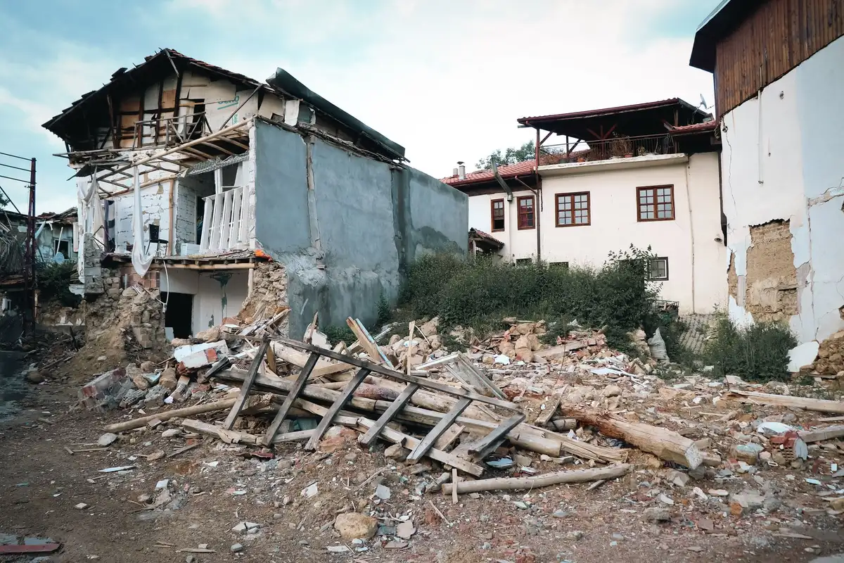 Row of severely damaged and collapsed residential houses after earthquake
