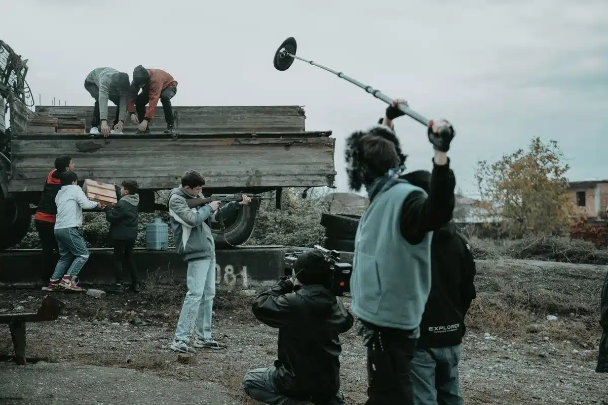 Film production crew and equipment on location at a historic estate