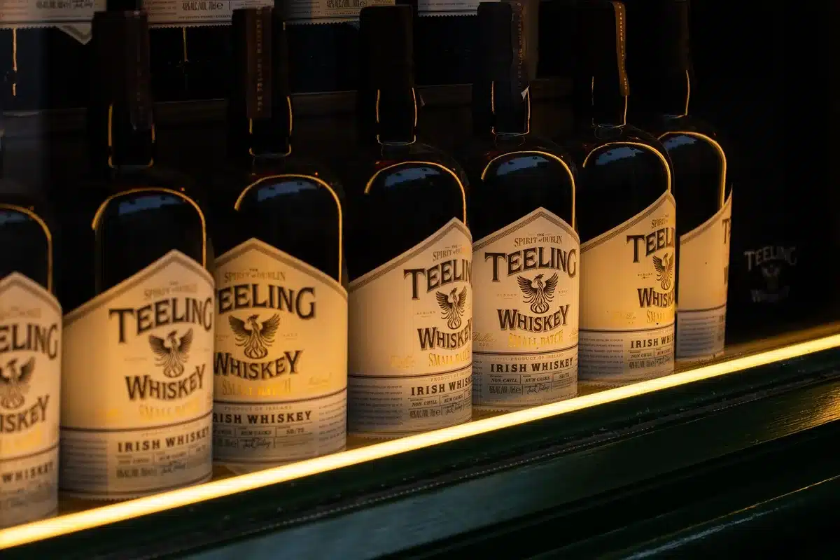 Craft Irish whiskey bottles and distillery equipment representing quality spirits