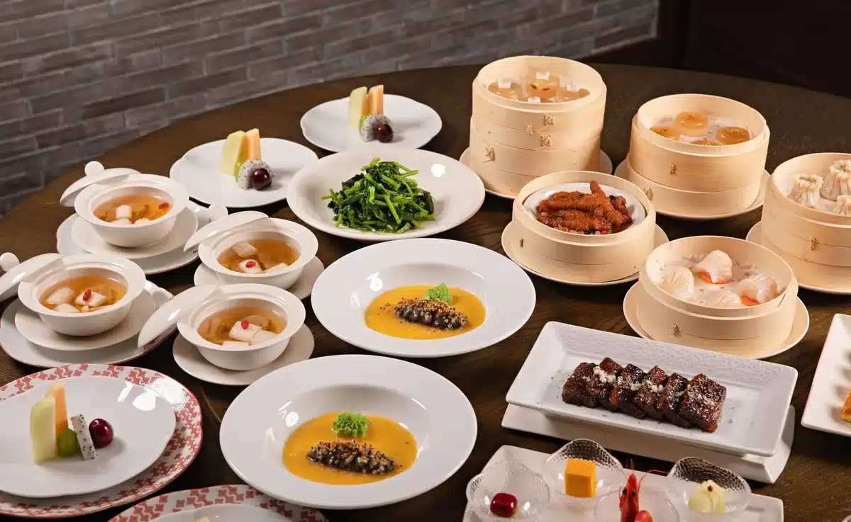 Elegant fine dining table with cocktail and plated course in intimate restaurant setting