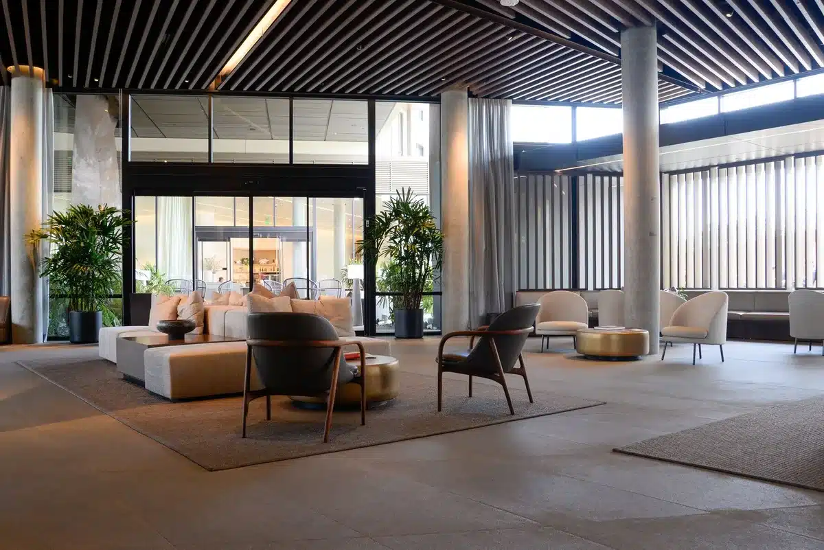 Upscale hotel interior with marble architecture, grand staircase and spa entrance in soft lighting