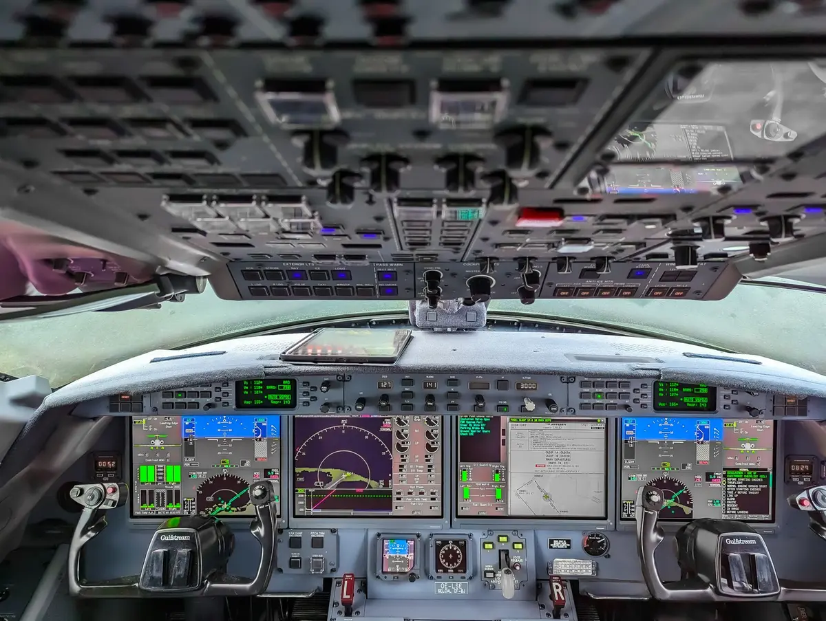 Modern aircraft flight deck with instruments and controls during a commercial flight