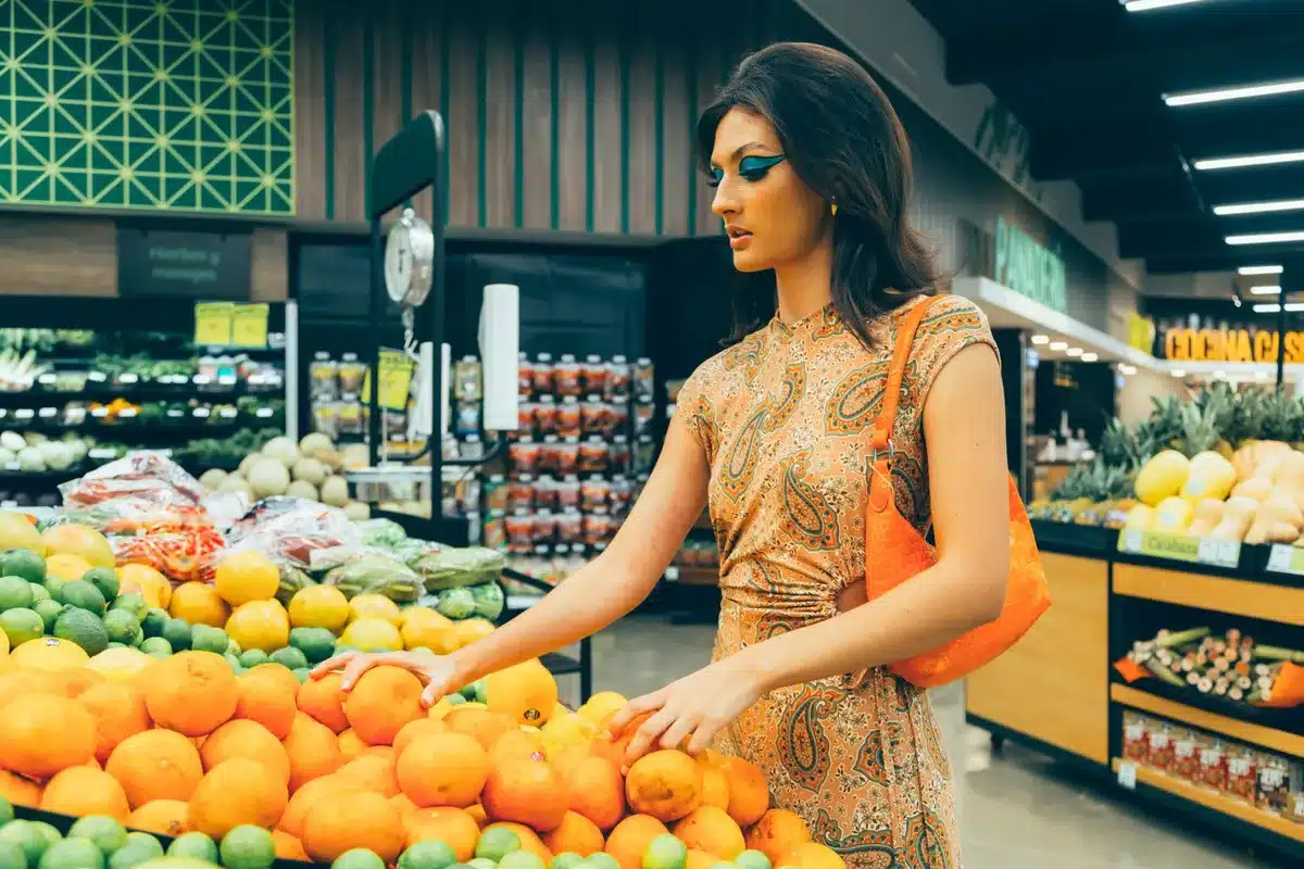 Neon orange strapless midi dress with pink floral detail on bust