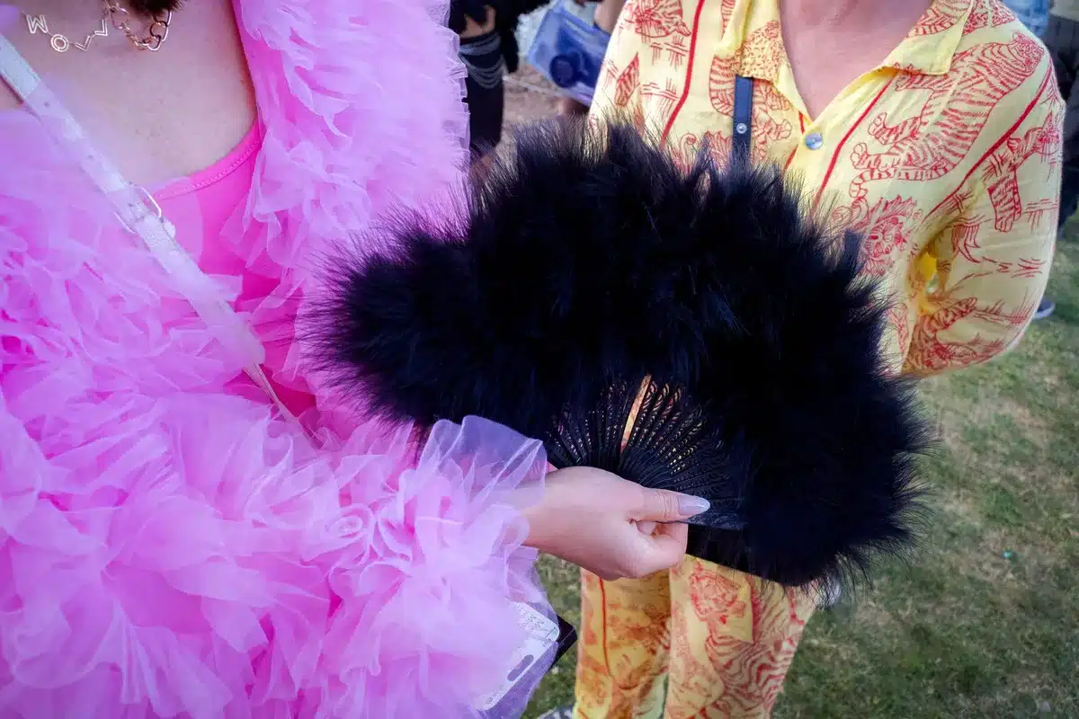 Style judge assessing fashion and accessories at outdoor racing event
