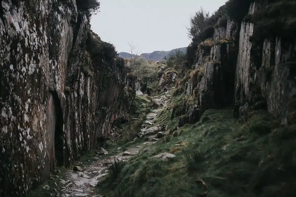Steep rocky hiking trail winding through open moorland terrain