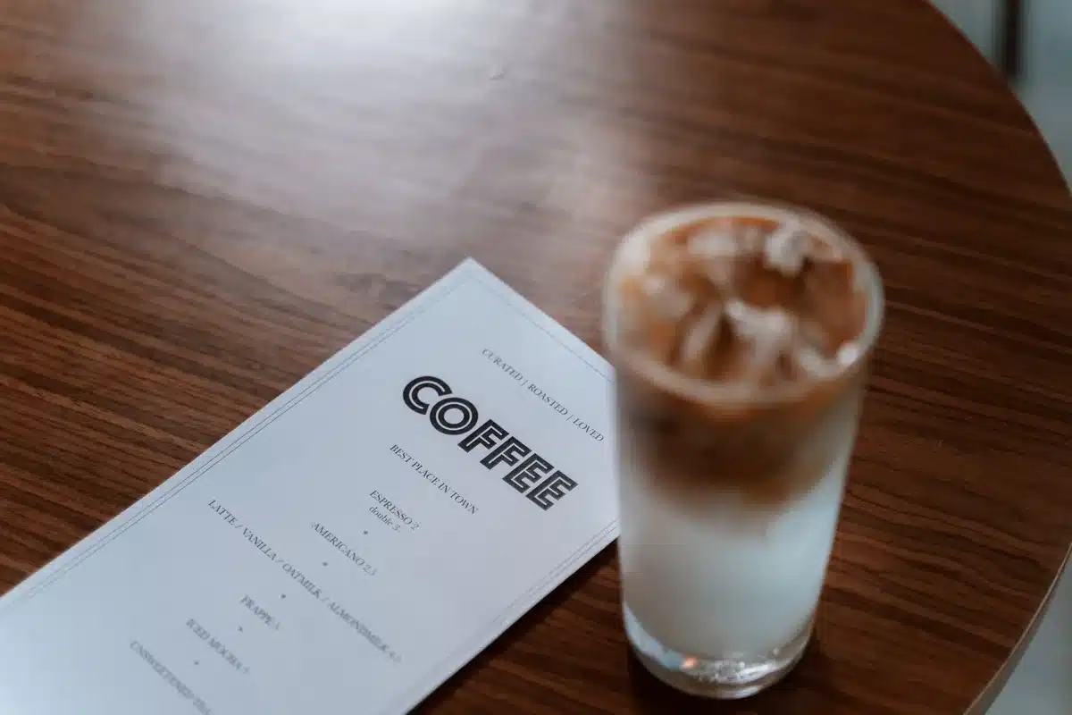 Selection of iced coffee and latte drinks displayed on a café menu board