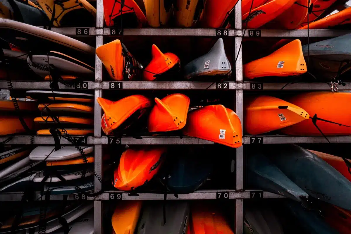 Rowing shell resting on wooden racking in a boat storage facility