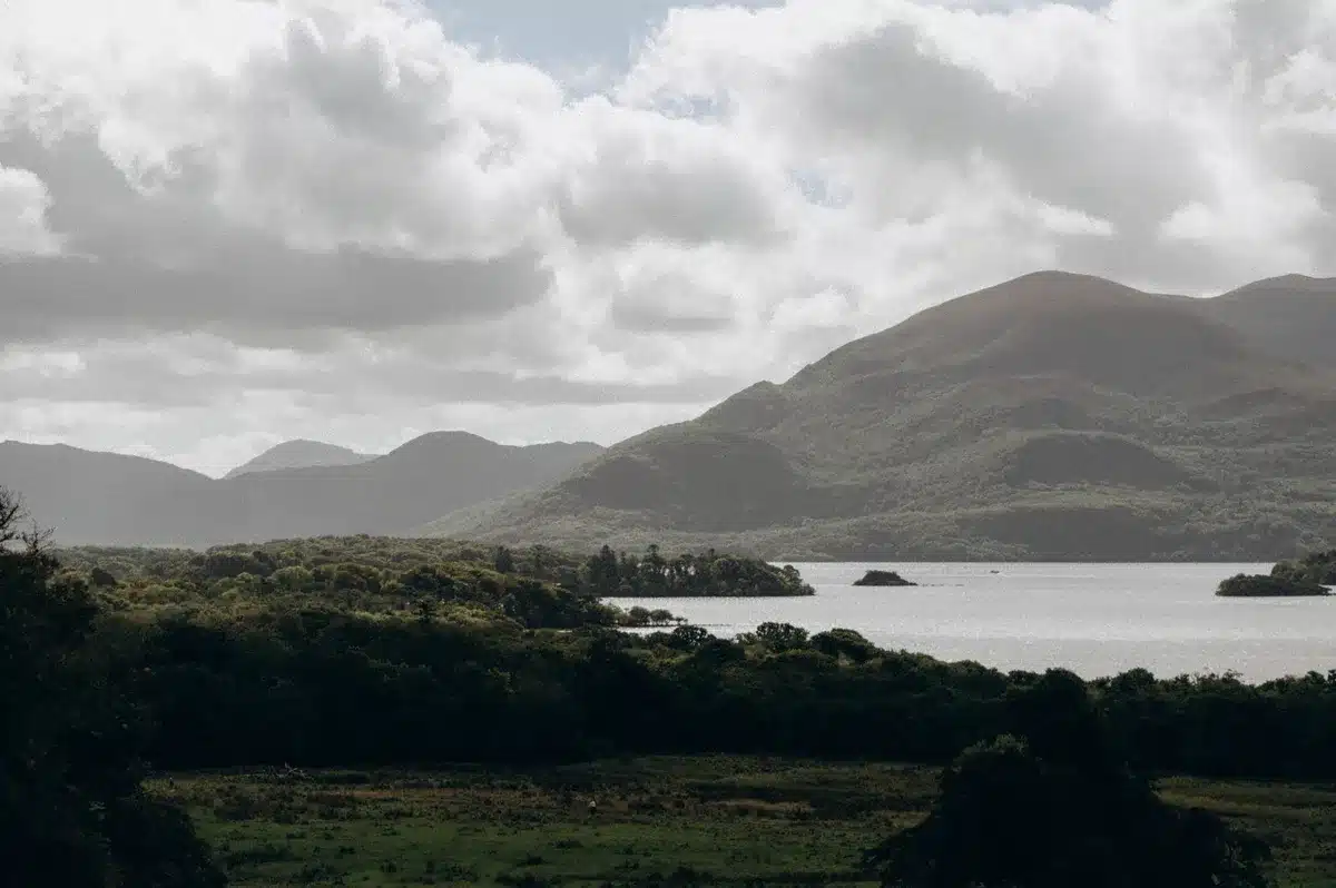 Panoramic view from a mountain ridge overlooking a lough and distant mountains
