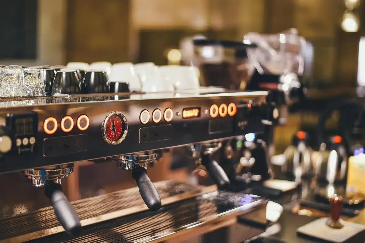 Barista-style coffee machine dispensing a cup at a forecourt counter