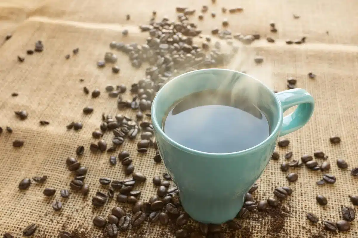 Chilled iced coffee in a clear cup with condensation on a counter