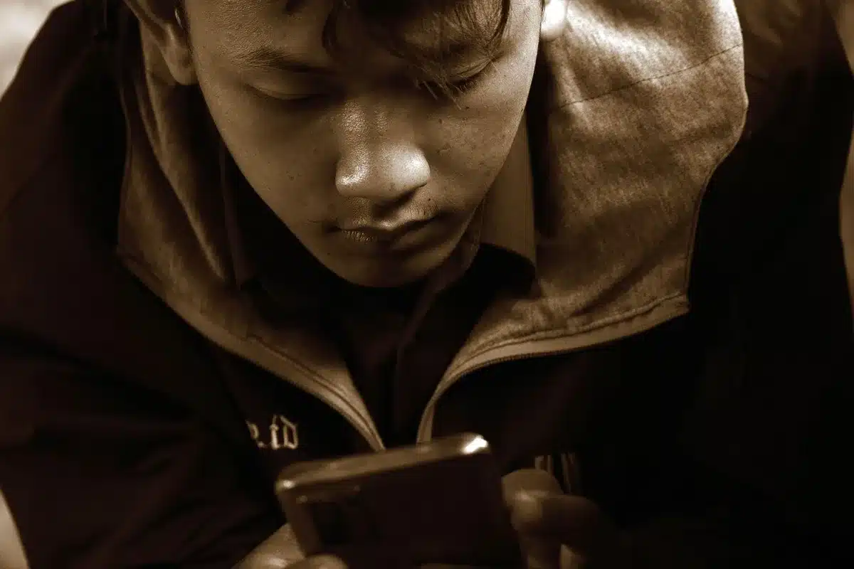 Man recording a short video message on a smartphone at home