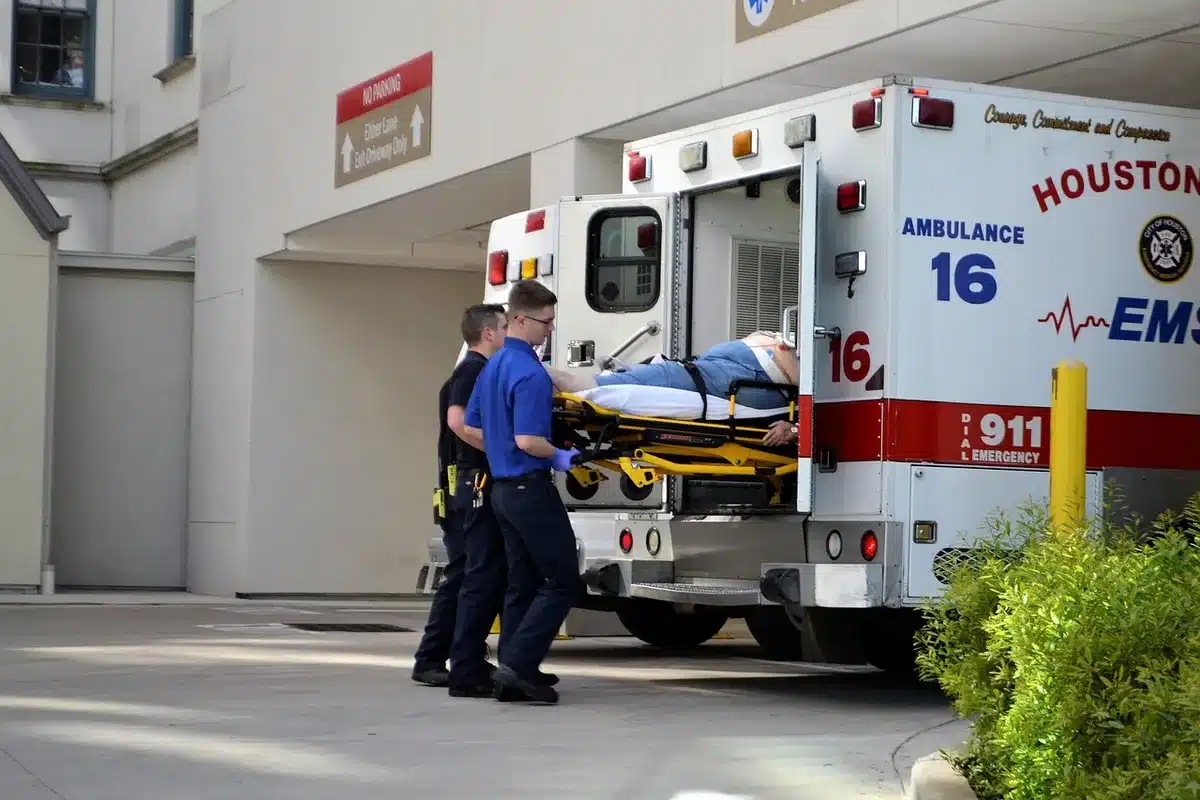 Paramedics attending to a patient being taken into an ambulance