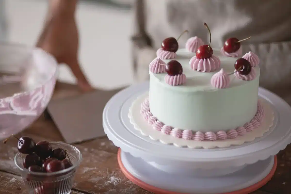 Homely kitchen table with baking tools and a cake in progress