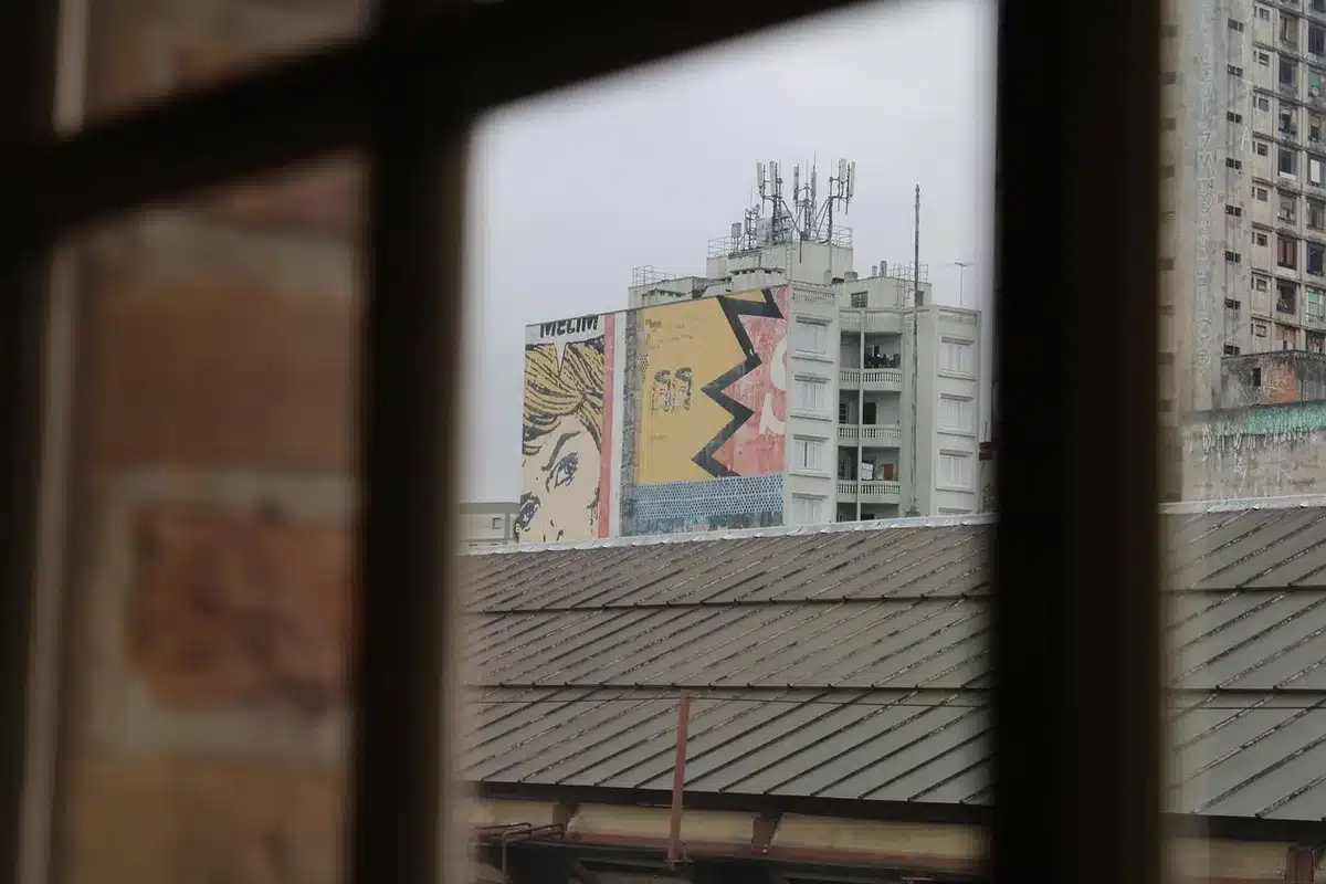 Colourful public murals on brick buildings in a bright town street