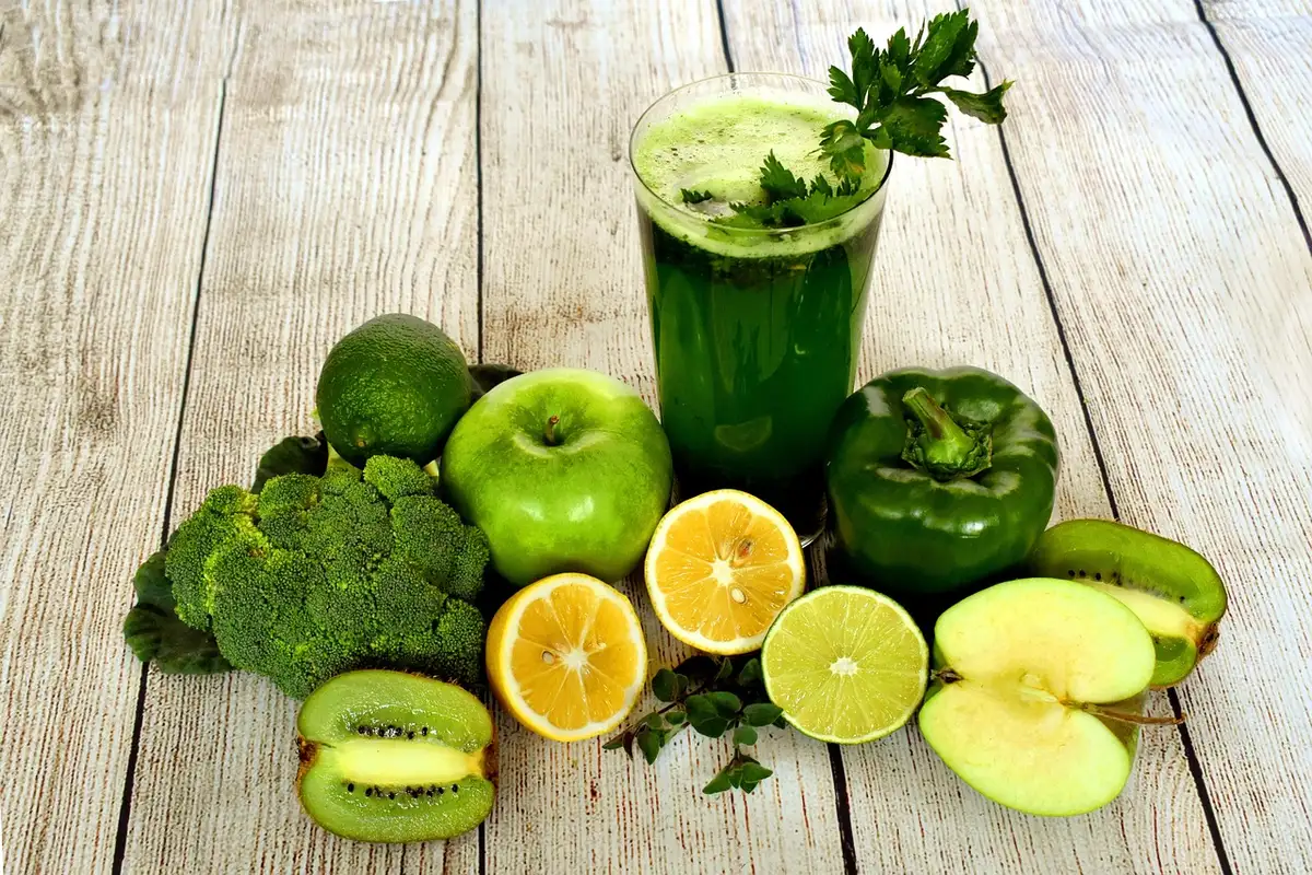 A modern café counter displaying fresh juices, smoothies and coffee drinks in a busy retail environment