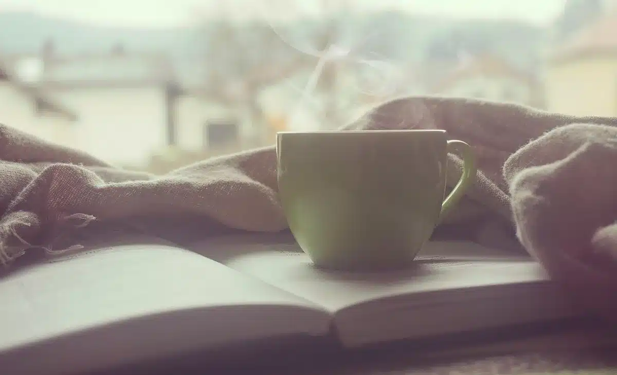 A person enjoying a quiet coffee moment at home, embodying daily ritual and grounding