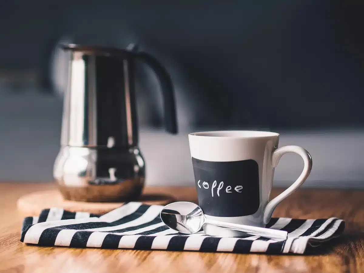 Limited-edition coffee accessories including a tumbler and travel mug with refined branding