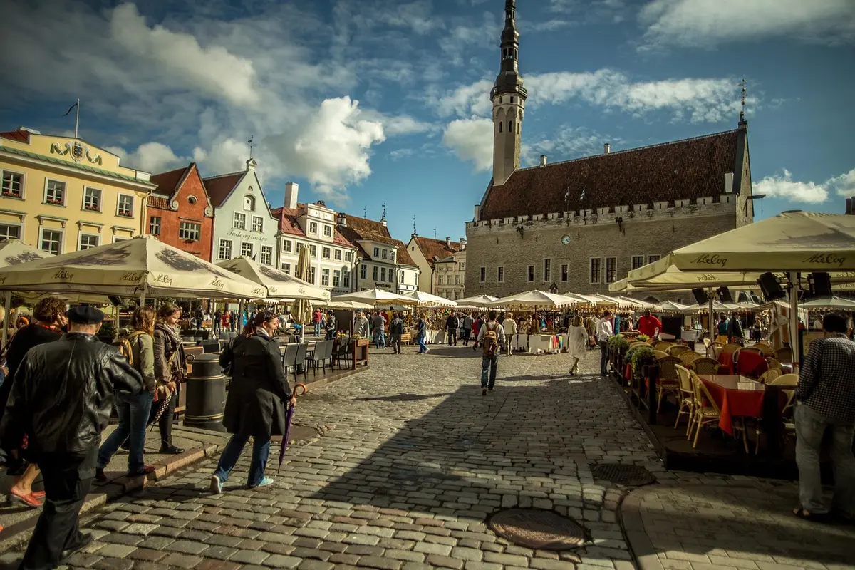 Tallinn Old Town square with Christmas fir and wooden market stalls in daylight