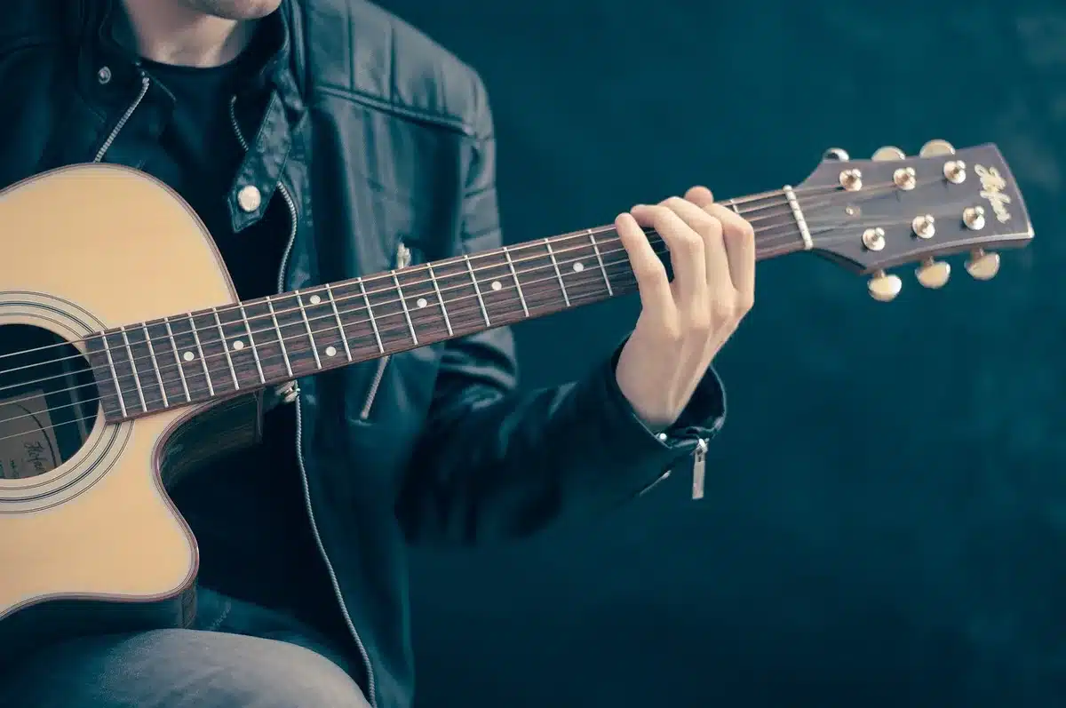 Acoustic guitar on a small bar stage in daylight