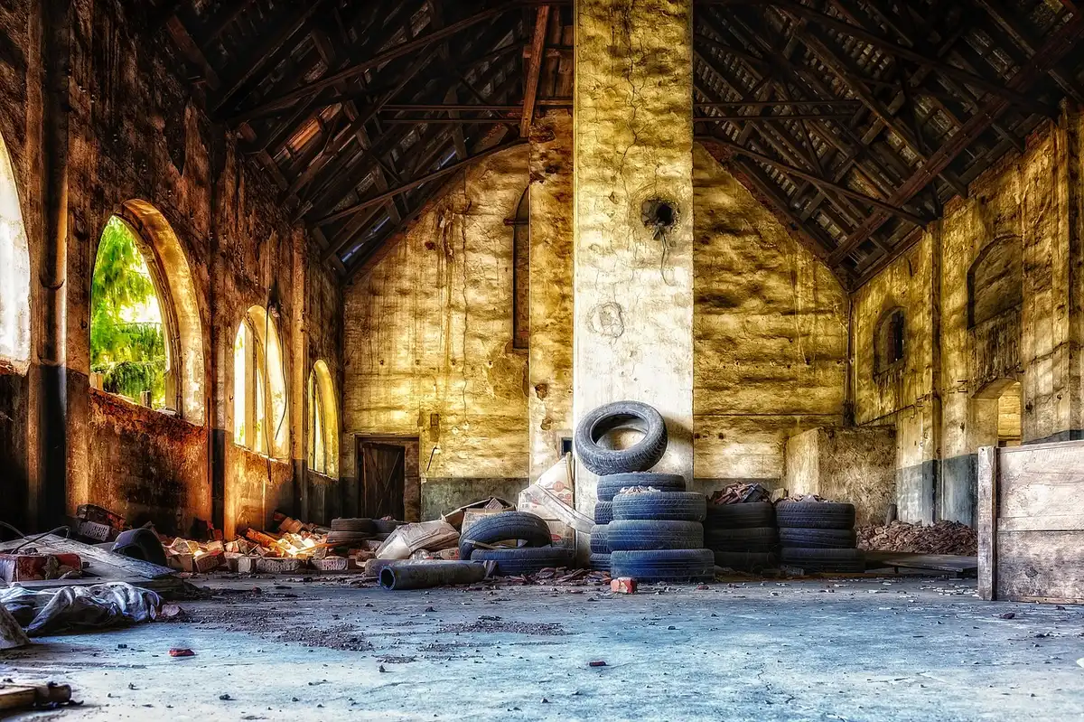 Interior reception with exposed brick, large arched windows and timber detailing