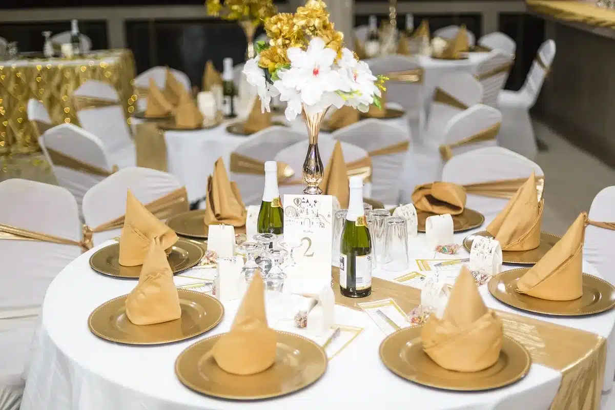 Gala tables set for a dinner in a bright ballroom