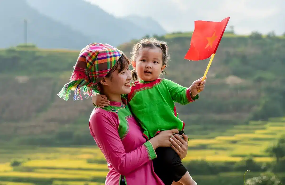 Families at an outdoor heritage event with storytellers and ancient landscape in daylight