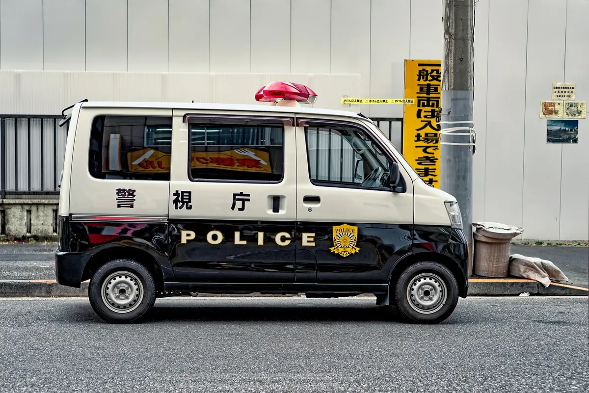 Police officers and a marked van on patrol in daylight
