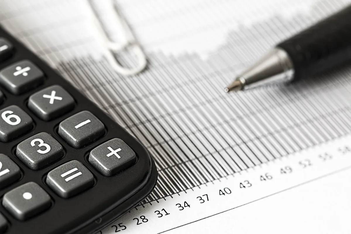 A house exterior with paperwork and a calculator on a nearby table