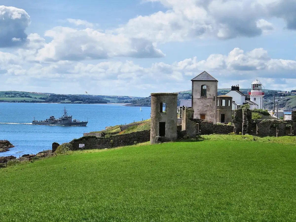 Small Irish coastal village and harbour seen from shoreline