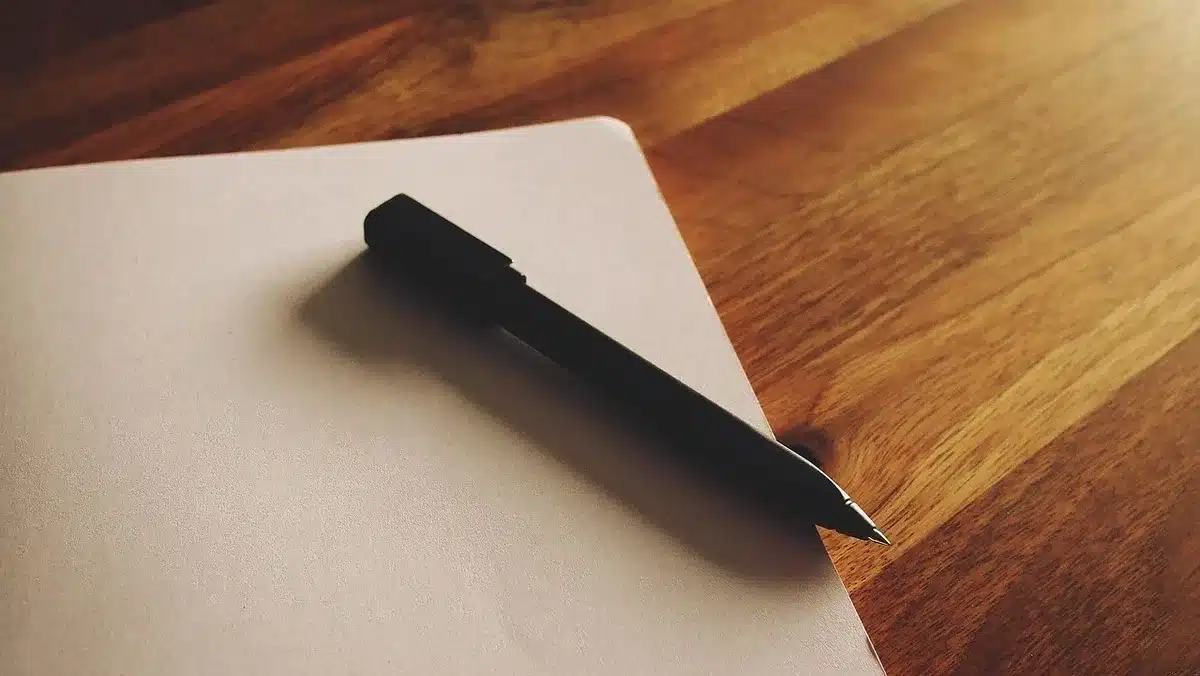 Tender documents and coffee on a desk with construction drawings
