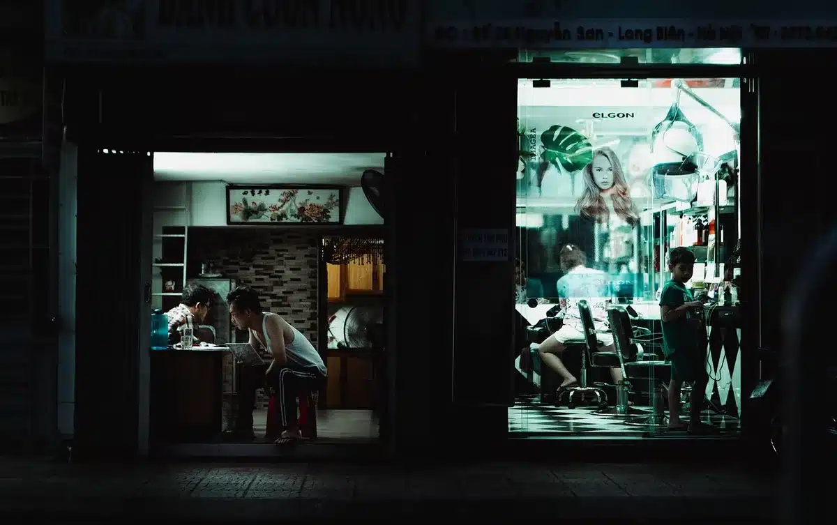 Storefront with closing-down sale signs and shoppers outside