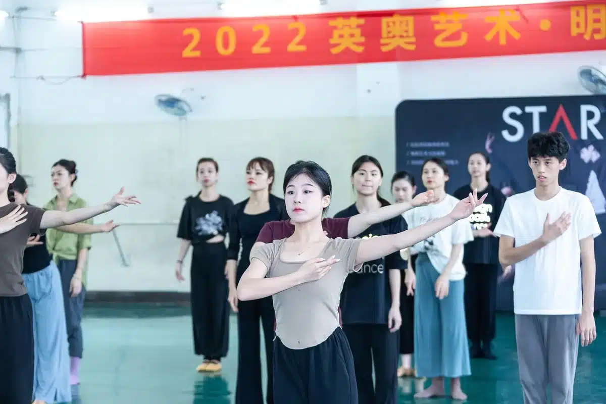 Actors rehearsing together in a bright theatre space