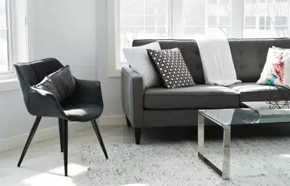 Sunlit living room with open manuscript on a coffee table and hands nearby