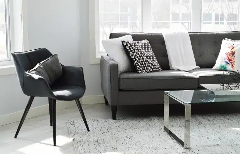 Sunlit living room with open manuscript on a coffee table and hands nearby