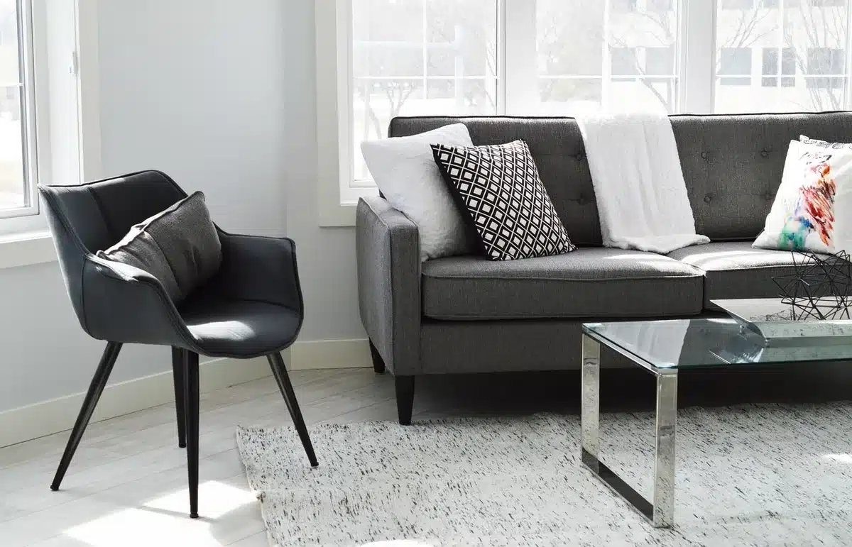Sunlit living room with open manuscript on a coffee table and hands nearby