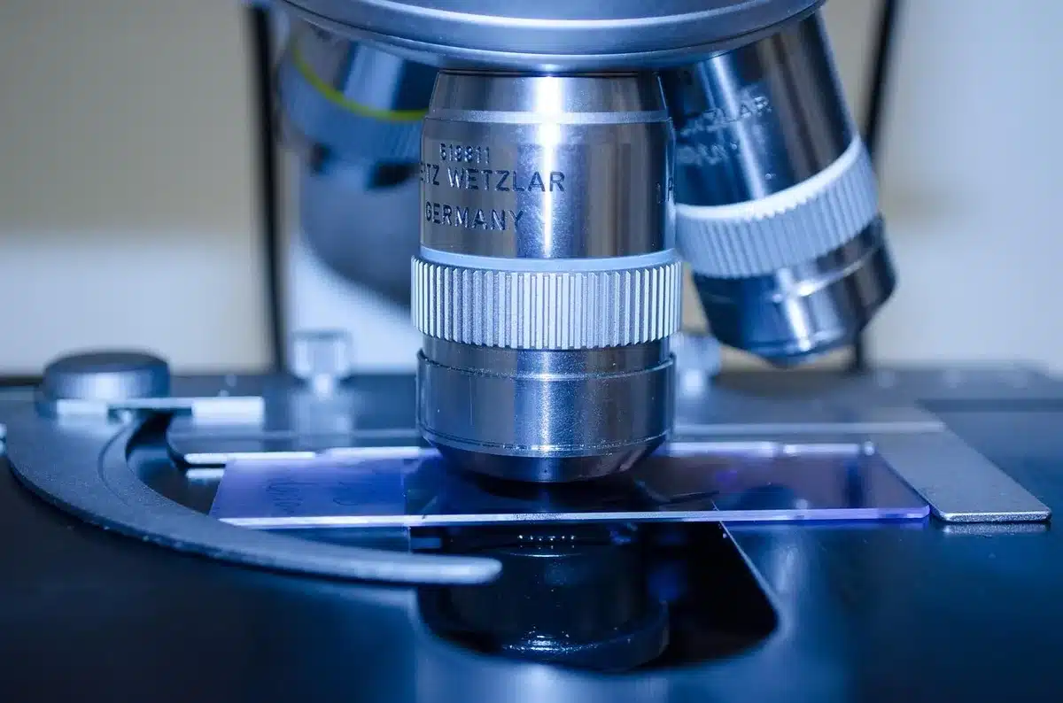 Scientist in a lab coat working at a bench, representing a state-backed researcher