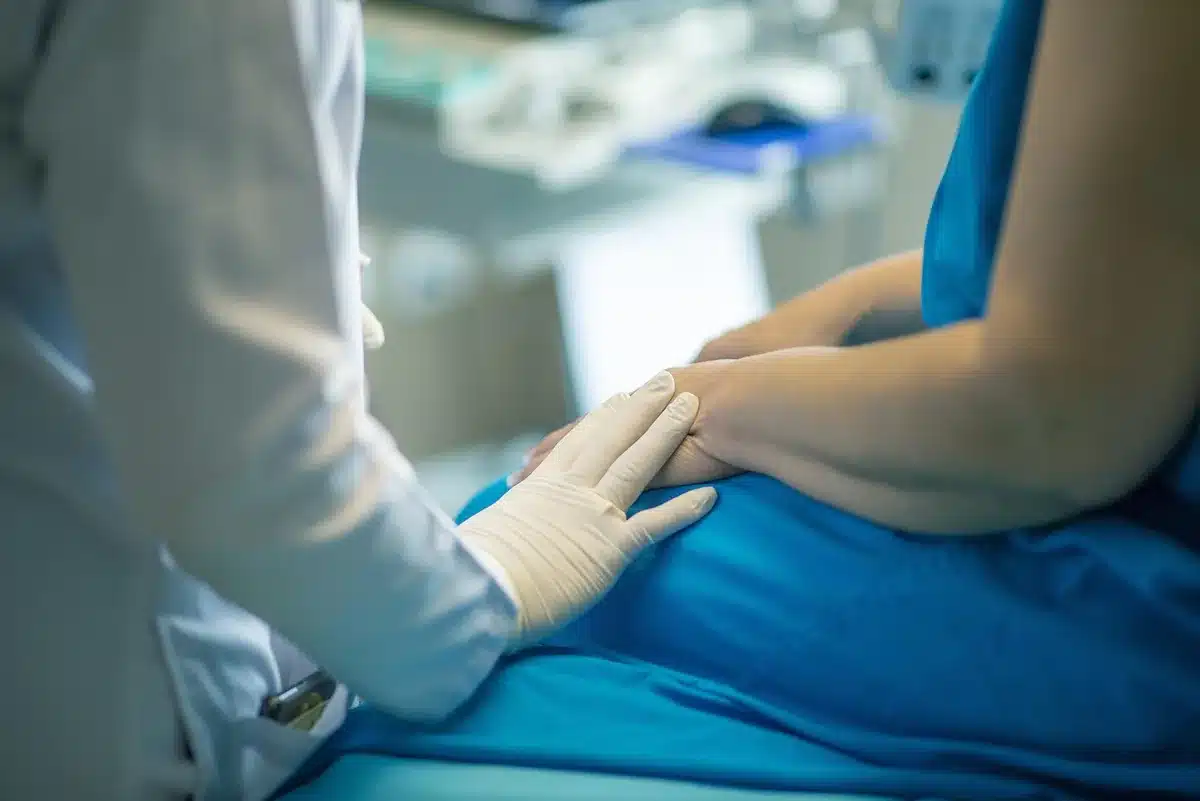 Clinician's hands with consultation papers and explanatory diagrams