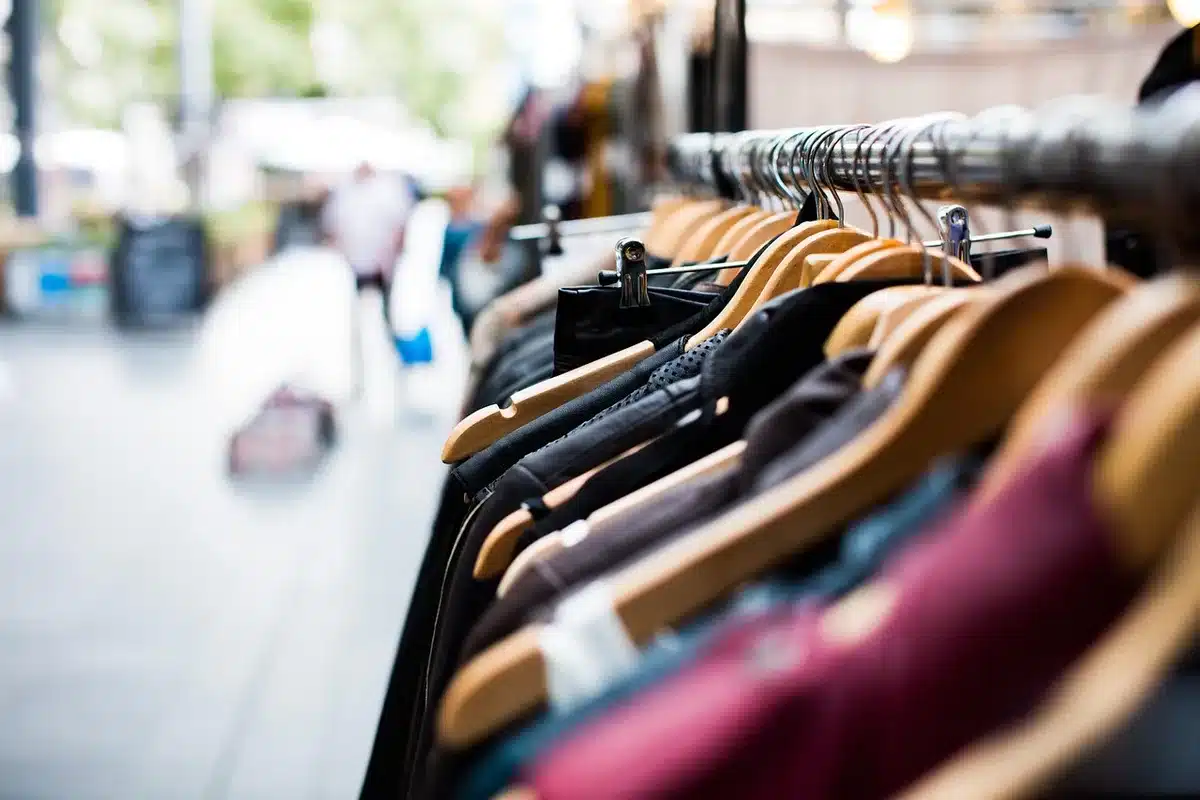 Rails of vintage dresses ranging from 1920s to 1980s in a shop