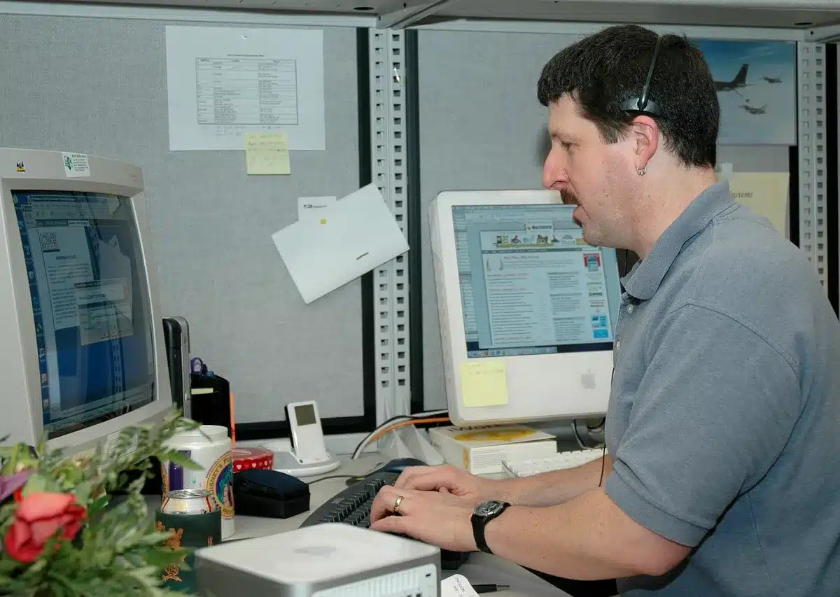 Content moderation team reviewing listings on screens in a bright office